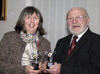 Val Kressman receiving the awards for Best Print and Best DPI in the General Category from Club President Bobby Haines